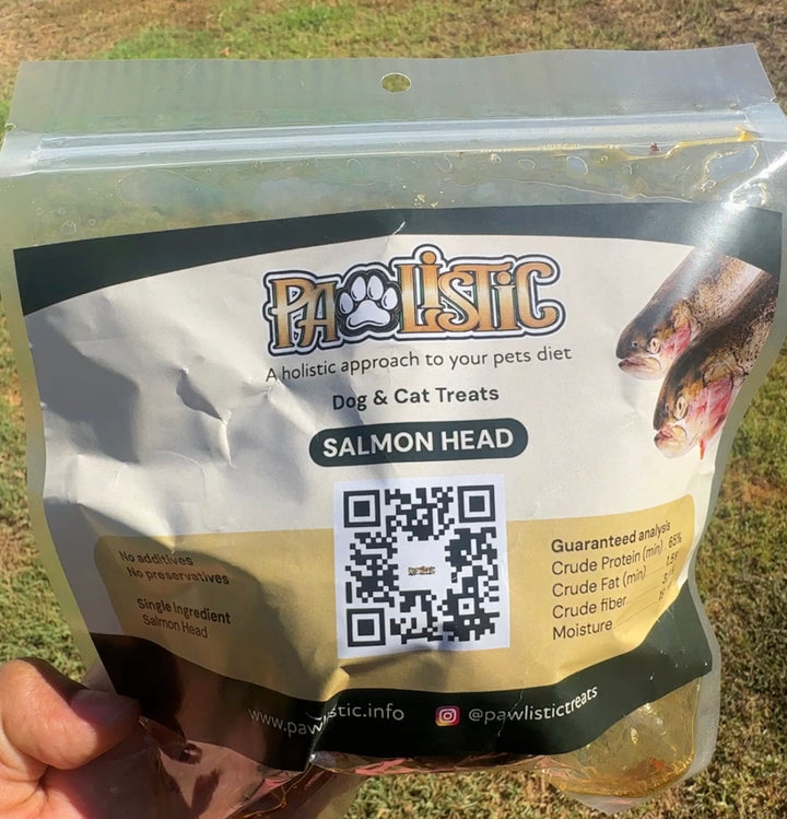 Image of a salmon head dog treat made by Pawlistic, displayed inside the packaging. The clear bag highlights the freshness and quality of the salmon head, emphasizing its nutritional benefits as a high-protein snack for dogs.